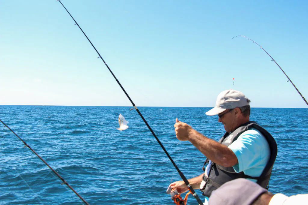man catching fish in fishing trips boat tour by algarexperience