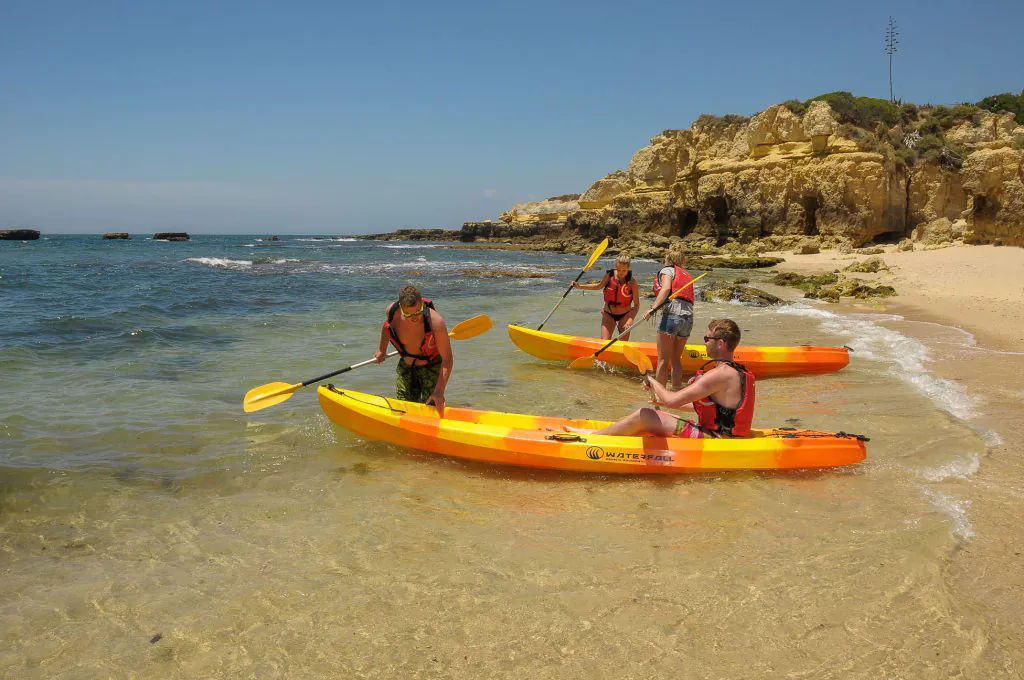 kayaks at the beach in kayaks & sup experience with barbecue algarexperience