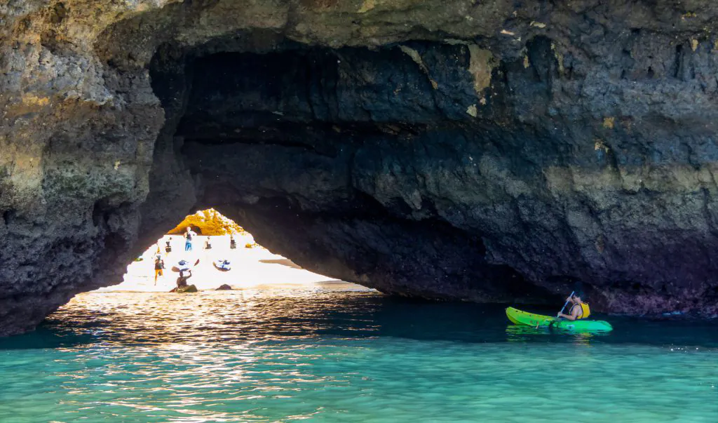 kayaks going into cave in algarve with algarexperience