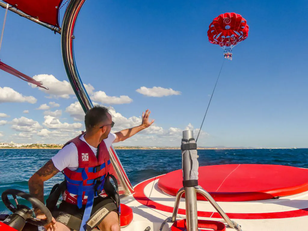 capitain of speed boat making parasailing water sports by algarexperience