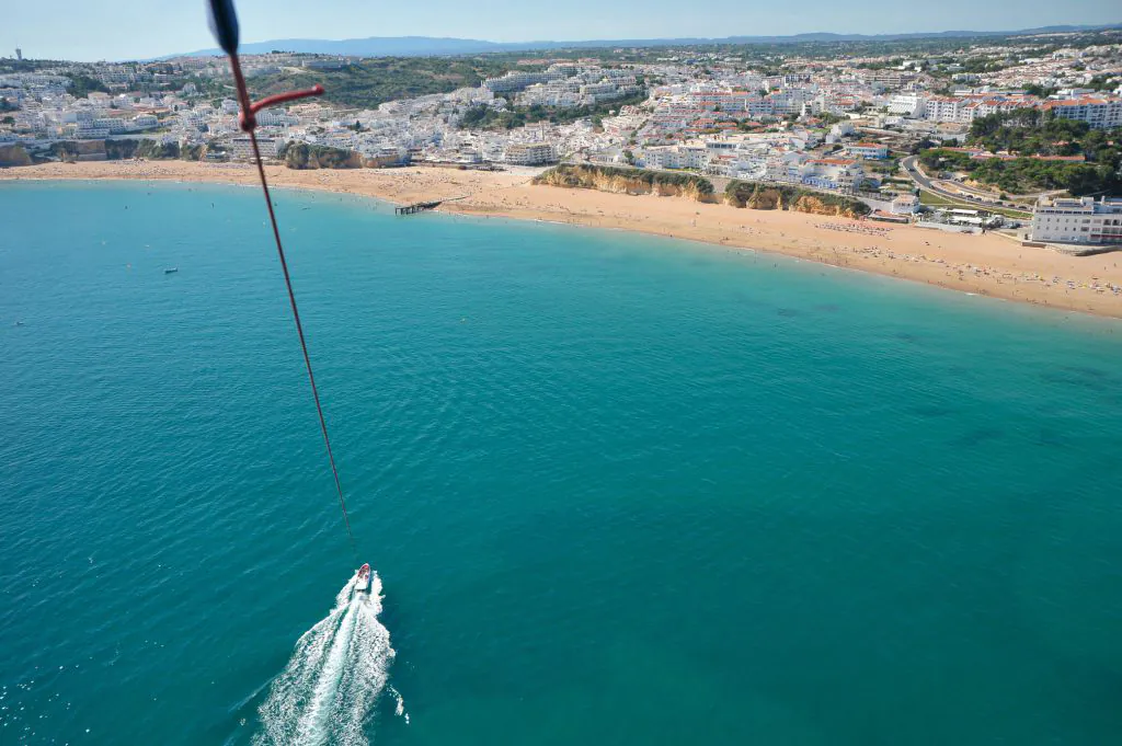 parasailing boat tour air view of the albufeira city by algarexperience